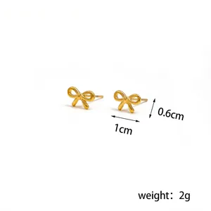 Detailed view of gold bow earrings with precise measurements 1cm x 0.6cm and 2g weight