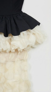 Detailed shot of 3D floral petals and waist pleats on black and white mermaid dress
