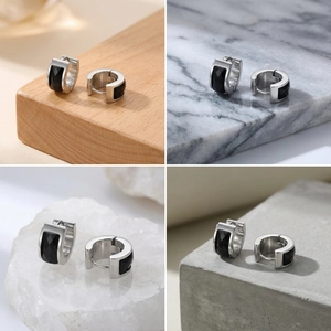 Detailed close-up of stainless steel huggie earrings featuring faceted black onyx stones