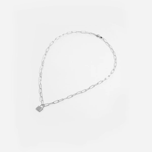 Detailed view of silver paperclip chain necklace with minimalist rectangular lock pendant