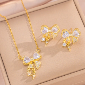 Elegant gold-plated bow jewelry set with sparkling crystals in a gift display box