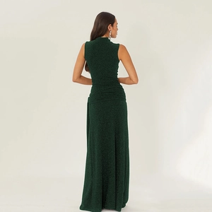 Elegant dark green sleeveless glitter maxi dress with waist pleats and fish tail design