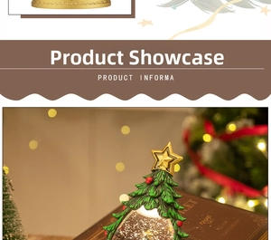 Detail of Christmas tree snow globe with golden star topper and festive ornaments