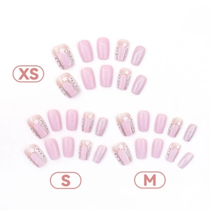 Pink and white star press-on nail set with glitter finish in sizes XS, S, and M