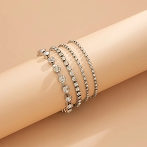 Detail of four-piece silver tennis bracelet set with sparkling crystals on a display