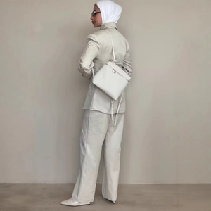 Women ivory chic suit set featuring lapel blazer and straight trousers with backpack