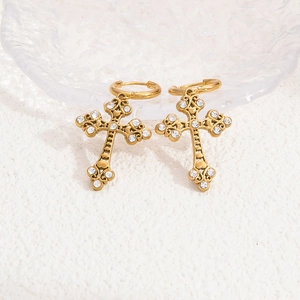 Detailed close-up of gold stainless steel cross earrings with sparkling white zircons