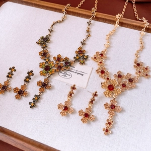 Detailed close-up of floral jewelry set featuring colorful rhinestones and bronze alloy
