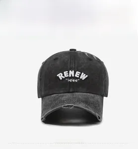 Front view of black distressed denim baseball cap with white RENEW idea embroidery