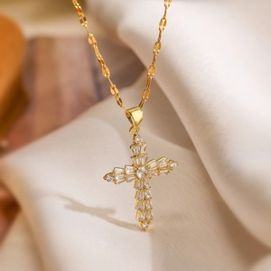 Gold plated cross pendant necklace featuring shimmering baguette and round cubic zirconia