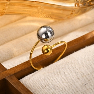 Adjustable stainless steel ring with dual-tone gold and grey metal beads on beige linen