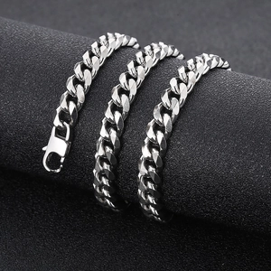 Macro shot of silver titanium steel Cuban link chain with lobster clasp on black cylinder