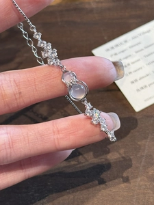 Macro view of silver gourd pendant bracelet with embedded white stones and zircons