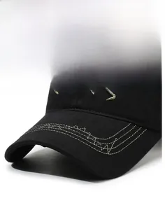 Close-up of black cotton twill baseball cap with decorative white stitching on the brim