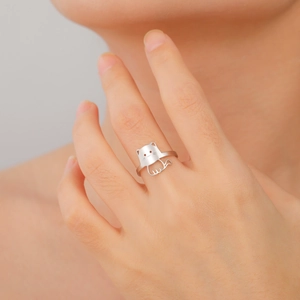 Stylized silver stainless steel cat ring for women shown on model finger in a close-up view