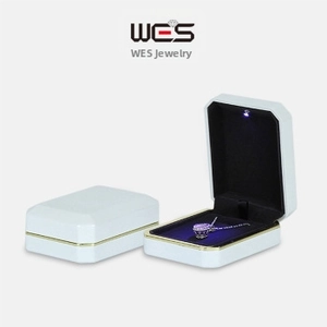 Elegant white LED jewelry box with golden frame and black velvet lining for necklaces