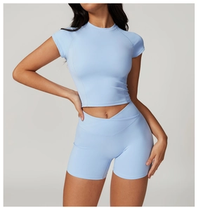 Detail of light blue high-waist yoga shorts with cross-over waist design and slim-fit top