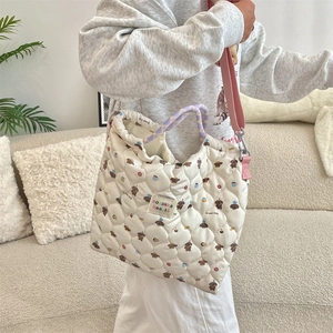 Detailed view of quilted tote bag with cute bread dog print and pink canvas strap