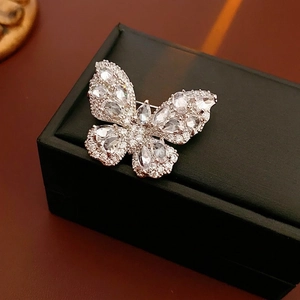 Elegant silver butterfly brooch with clear zircon crystals on black leather jewelry box