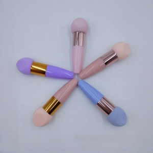 Macro view of five colorful makeup sponge brushes with metallic handles arranged in a star pattern
