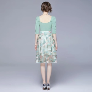 Women's summer two-piece set featuring light green top and floral embroidery midi skirt