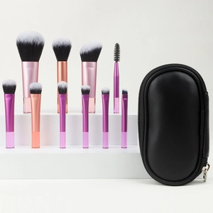 Detailed view of 10 portable makeup brushes with rose gold handles and a leather pouch