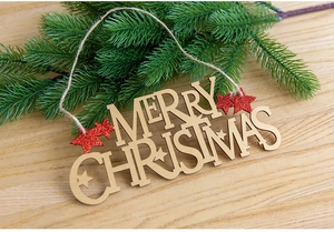 Macro detail of wooden Merry Christmas sign with red glitter star and natural jute rope