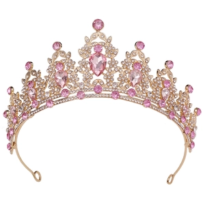 Detailed view of golden leaf crown with pink crystals and shimmering rhinestones