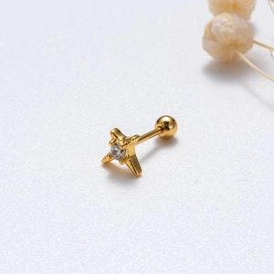 Macro shot of gold cross stud earring with sparkling zircon and secure screw ball back