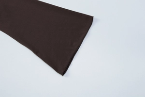 Détail du poignet de la manche du t-shirt marron foncé en tissu maille serrée