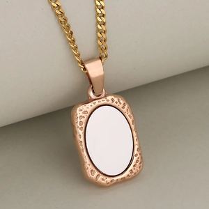 Minimalist rectangular rose gold frame pendant with white oval inlay on a cuban chain
