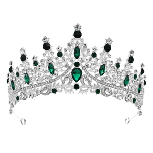 Close-up of green crystal emeralds and sparkling diamonds on a silver bridal tiara