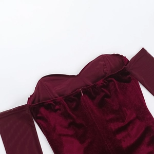 Detail of off-the-shoulder neckline and invisible zipper on burgundy velvet dress