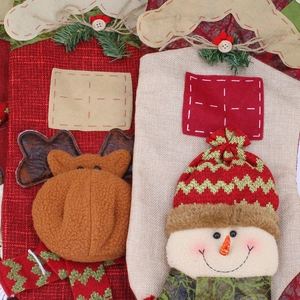 Christmas stocking decorations featuring reindeer and snowman patterns in burlap and knit