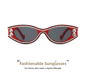 Detail shot of red slim oval sunglasses with sparkling rhinestones and dark lenses
