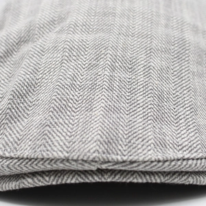 Macro view of grey herringbone pattern on high-quality wool blend flat cap fabric