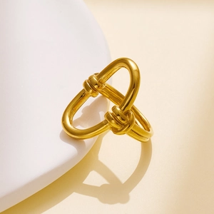 Macro shot of 18k gold plated stainless steel ring with twisted knot design and smooth finish