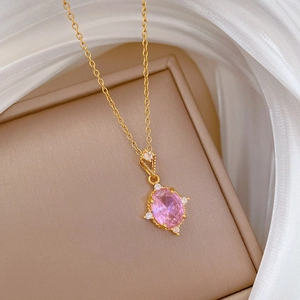Pink oval crystal pendant on gold titanium chain with small diamonds on white silk
