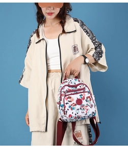 Detail of floral nylon backpack with red logo and smooth zippers for women