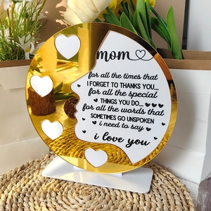 Macro shot of gold mirror acrylic Mother’s Day sign with loving message and white base