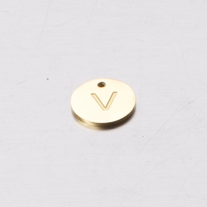 Macro shot of 12mm gold mirror stainless steel pendant with engraved letter V detail