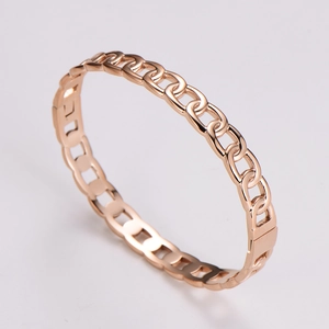 Detailed view of a rose gold chain link bracelet with sparkling diamond accents