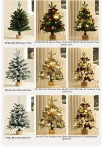 Close-up of mini flocked Christmas tree with LED lights and festive ornaments on wooden base