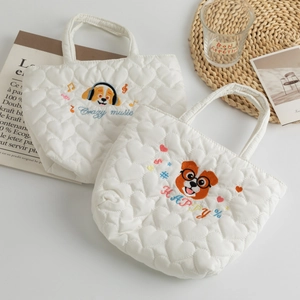 Detail of heart quilting and cute dog embroidery on white canvas lunch handbags