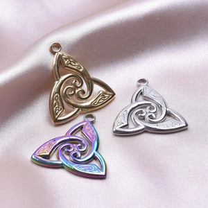Detailed macro view of Celtic knot pendants in gold, silver, and rainbow finishes