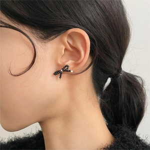 Side view of model wearing elegant black beaded bow earrings in Korean minimalist style