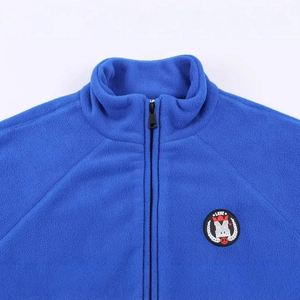 Royal blue soft fleece jacket with a high neck and round brand logo on the chest