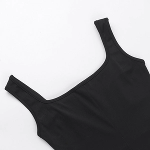 Close-up of wide shoulder straps and square neckline on a black slim fit dress