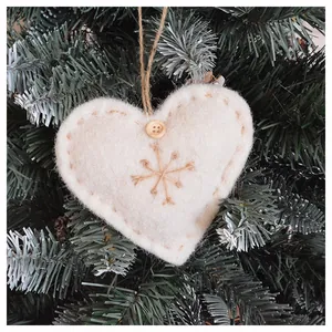 Handmade wool felt heart ornament with snowflake embroidery and wood button detail