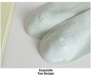 Macro view of light green mesh cotton socks showing breathable knit pattern and flat toe seam